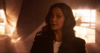 Movie still from “Super Troopers 2” (2018), directed by Jay Chandrasekhar – A woman with long dark hair wearing a black jacket; Close Up shot, Over the shoulder angle