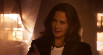 Movie still from “Super Troopers 2” (2018), directed by Jay Chandrasekhar – A woman with long dark brown hair wearing a white shirt; Close Up shot, Over the shoulder angle