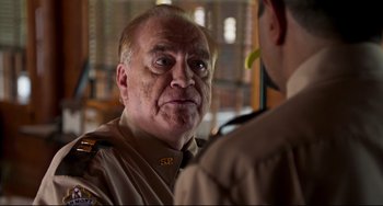 Movie still from “Super Troopers 2” (2018), directed by Jay Chandrasekhar – An older man wearing a uniform looking at a younger man; Close Up shot, Over the shoulder angle