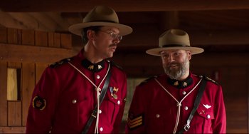 Movie still from “Super Troopers 2” (2018), directed by Jay Chandrasekhar – A couple of men in red jackets standing next to each other; Medium shot, Low angle