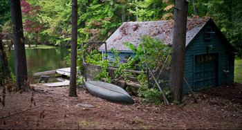 Movie still from “Super Troopers 2” (2018), directed by Jay Chandrasekhar – A boat is parked in front of a house; Extreme Wide shot, High angle