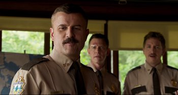 Movie still from “Super Troopers 2” (2018), directed by Jay Chandrasekhar – A group of men standing next to each other in uniform; Close Up shot, Low angle