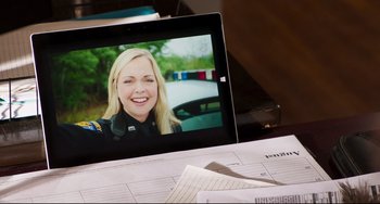 Movie still from “Super Troopers 2” (2018), directed by Jay Chandrasekhar – A laptop computer sitting on top of a desk; Close Up shot, Over the shoulder angle