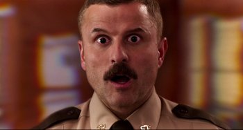 Movie still from “Super Troopers 2” (2018), directed by Jay Chandrasekhar – A person wearing a uniform; Close Up shot, Low angle