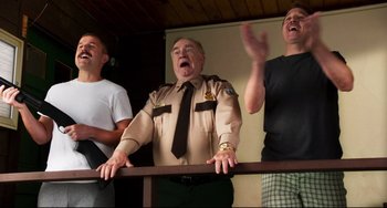 Movie still from “Super Troopers 2” (2018), directed by Jay Chandrasekhar – Three men are laughing and singing together; Medium shot, Low angle