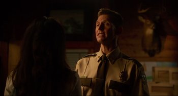 Movie still from “Super Troopers 2” (2018), directed by Jay Chandrasekhar – A man and a woman in uniform in a dark room; Close Up shot, Over the shoulder angle