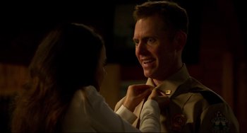 Movie still from “Super Troopers 2” (2018), directed by Jay Chandrasekhar – A woman helping a man put on a tie; Close Up shot, Over the shoulder angle