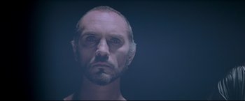 Movie still from “Superman II” (1980), directed by Richard Lester – A person with a beard looking at the camera; Close Up shot, Low angle