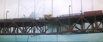 Movie still from “Superman II” (1980), directed by Richard Lester – A school bus on top of a wooden bridge; Extreme Wide shot, Low angle