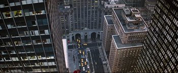Movie still from “Superman II” (1980), directed by Richard Lester – An aerial view of a city street with cars driving down it; Extreme Wide shot, Overhead angle