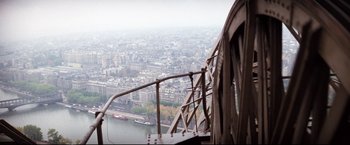 Movie still from “Superman II” (1980), directed by Richard Lester – A view of a city from the top of the eiffel tower; Wide shot, Low angle