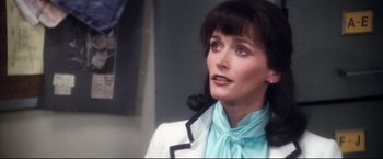 Movie still from “Superman II” (1980), directed by Richard Lester – A person wearing a suit and tie; Close Up shot, Over the shoulder angle