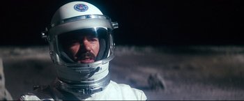 Movie still from “Superman II” (1980), directed by Richard Lester – A man in a spacesuit is standing on the moon; Close Up shot, Low angle