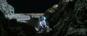 Movie still from “Superman II” (1980), directed by Richard Lester – A person in a spacesuit kneeling on the moon; Wide shot, High angle