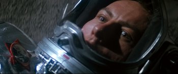 Movie still from “Superman II” (1980), directed by Richard Lester – A man's face in a space helmet; Close Up shot, Overhead angle