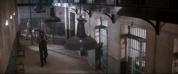 Movie still from “Superman II” (1980), directed by Richard Lester – A bell hanging from a ceiling inside a building; Extreme Wide shot, High angle