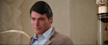 Movie still from “Superman II” (1980), directed by Richard Lester – A man with a sweater on is looking at the camera; Close Up shot, Over the shoulder angle