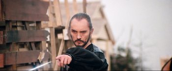 Movie still from “Superman II” (1980), directed by Richard Lester – A man with a beard is pointing at the camera; Close Up shot, Low angle