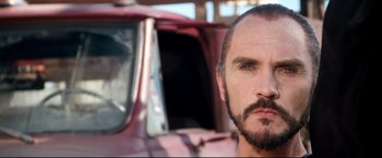 Movie still from “Superman II” (1980), directed by Richard Lester – A person with a beard and mustache; Close Up shot, Low angle