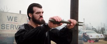 Movie still from “Superman II” (1980), directed by Richard Lester – A bearded man holding an object in his hands; Close Up shot, Low angle