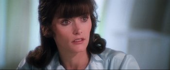 Movie still from “Superman II” (1980), directed by Richard Lester – A person wearing a white shirt; Close Up shot, Over the shoulder angle