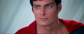 Movie still from “Superman II” (1980), directed by Richard Lester – A man with blue eyes looking at the camera; Close Up shot, Over the shoulder angle