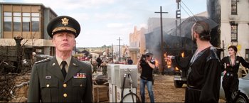 Movie still from “Superman II” (1980), directed by Richard Lester – A group of people standing next to each other on a dirt road; Wide shot, Low angle