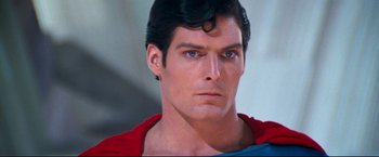 Movie still from “Superman II” (1980), directed by Richard Lester – A person wearing a superman costume; Close Up shot, Over the shoulder angle