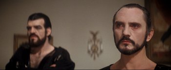 Movie still from “Superman II” (1980), directed by Richard Lester – Two people standing next to each other in front of a mirror; Close Up shot, Over the shoulder angle