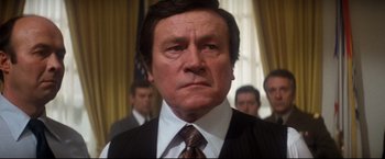 Movie still from “Superman II” (1980), directed by Richard Lester – A man in a suit and tie; Close Up shot, Low angle