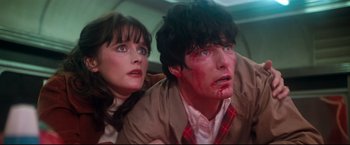 Movie still from “Superman II” (1980), directed by Richard Lester – A man and a woman with blood all over their faces; Close Up shot, Low angle