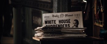 Movie still from “Superman II” (1980), directed by Richard Lester – A stack of newspapers on top of each other on a table; Extreme Close Up shot, Low angle