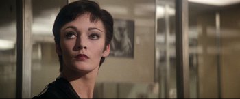 Movie still from “Superman II” (1980), directed by Richard Lester – A person with short black hair; Close Up shot, Over the shoulder angle
