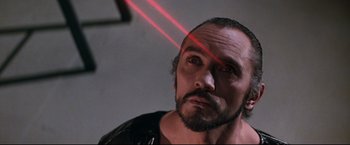 Movie still from “Superman II” (1980), directed by Richard Lester – A person with a laser beam in their face; Close Up shot, Low angle