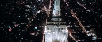 Movie still from “Superman II” (1980), directed by Richard Lester – An aerial view of a large building at night; Extreme Wide shot, High angle