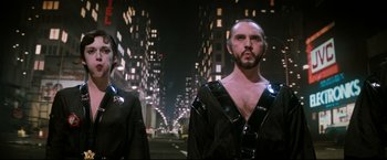 Movie still from “Superman II” (1980), directed by Richard Lester – A man with a beard is standing next to another man; Medium shot, Low angle