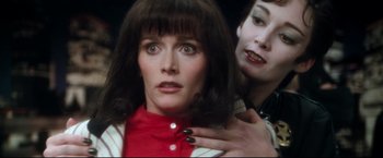 Movie still from “Superman II” (1980), directed by Richard Lester – A woman with her hand on the shoulder of another woman; Close Up shot, Over the shoulder angle