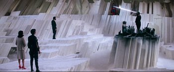 Movie still from “Superman II” (1980), directed by Richard Lester – A man standing in front of a wall made out of marble; Extreme Wide shot, High angle