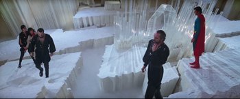 Movie still from “Superman II” (1980), directed by Richard Lester – A man standing in a room with a lot of white stuff on the floor; Extreme Wide shot, High angle