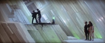 Movie still from “Superman II” (1980), directed by Richard Lester – Two men standing on a ledge in a building; Extreme Wide shot, Overhead angle