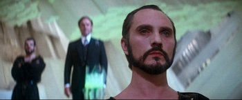 Movie still from “Superman II” (1980), directed by Richard Lester – A man with a beard standing next to another man; Close Up shot, Low angle