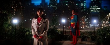 Movie still from “Superman II” (1980), directed by Richard Lester – A man and a woman dressed as superman and wonder woman in front of a city skyline at night; Wide shot, Low angle