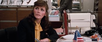 Movie still from “Superman III” (1983), directed by Richard Lester – A woman sitting at a table in a restaurant; Medium shot, Over the shoulder angle