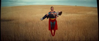 Movie still from “Superman III” (1983), directed by Richard Lester – A man holding a woman while flying through the air; Wide shot, Low angle