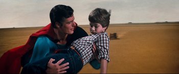 Movie still from “Superman III” (1983), directed by Richard Lester – A man and a boy in the middle of a field; Medium shot, High angle