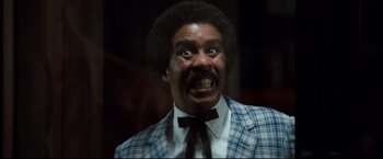 Movie still from “Superman III” (1983), directed by Richard Lester – A man with a surprised look on his face; Close Up shot, Low angle