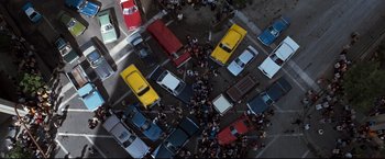 Movie still from “Superman III” (1983), directed by Richard Lester – An aerial view of a busy street with cars and buses; Extreme Wide shot, Overhead angle
