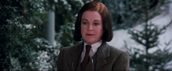 Movie still from “Superman III” (1983), directed by Richard Lester – A person wearing a suit and tie; Close Up shot, Over the shoulder angle