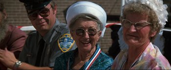 Movie still from “Superman III” (1983), directed by Richard Lester – An older woman wearing a white hat and sunglasses; Close Up shot, Low angle