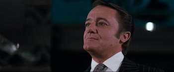 Movie still from “Superman III” (1983), directed by Richard Lester – A person wearing a suit and tie; Close Up shot, Low angle